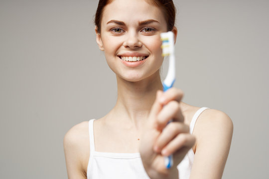 Woman Smiling Holding A Toothbrush Care