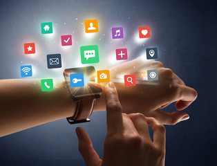 Naked female hand with smartwatch and  application labels around and dark background