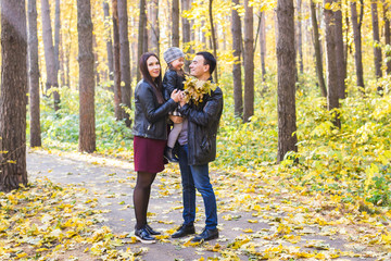 Parenthood, fall and people concept - young family happy in autumn park