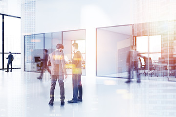 Businessmen in modern office lobby