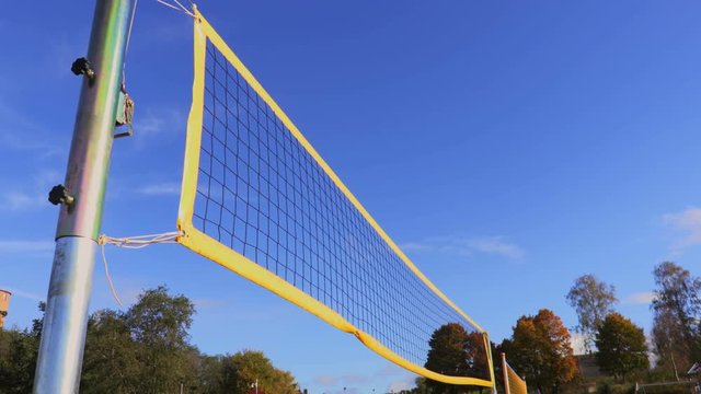 Yellow volleyball net in wind
