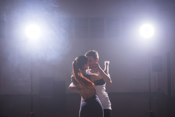 Active happy adults dancing bachata together in dance class