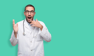 Amazed young doctor posing