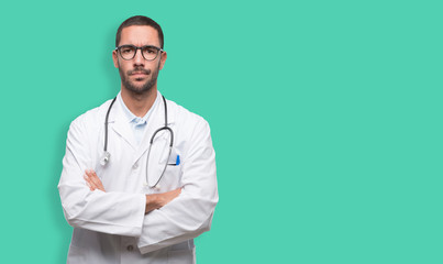 Serious young doctor with crossed arms gesture