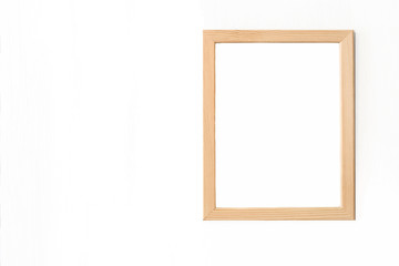 Blank light wooden frame for picture hanging on white wall. Realistic vector illustration