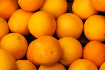 Oranges in a wooden box as a background