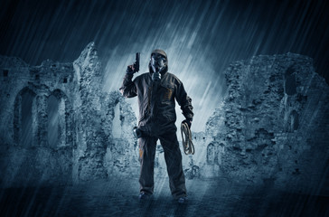 Hazard, menace man in a ruined crumbly building with arms on his hand
