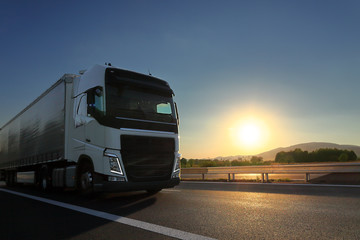 Truck transport on the road at sunset 