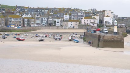 Fishing boats within St Ives harbour at dawn.