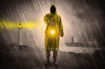 Man at the coast coming in raincoat with glowing lantern concept

