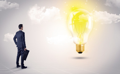 Obraz premium Businessman standing with his back with objects in his hand and looking at the globe, courtesy of NASA 