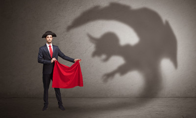 Businessman standing with red cloth in his hand and imp shadow on the background
