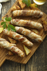 Grilled sausages wrapped with bacon