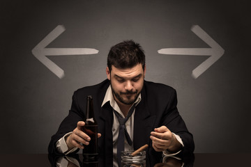 Drunk disappointed man sitting at table with arrows around
