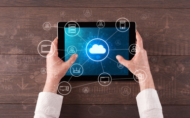 Hand touching tablet with cloud computing and online storage concept

