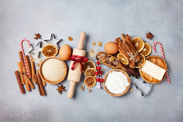 Bakery background with ingredients for cooking christmas baking. Flour, brown sugar, eggs and spices on kitchen table top view.
