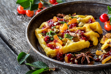 waffles Viennese with fresh cherries and nuts, mint