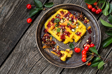 waffles Viennese with fresh cherries and nuts, mint