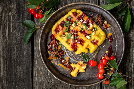 waffles Viennese with fresh cherries and nuts, mint