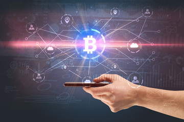 Hand using phone with cryptocurrency bitcoin link network and online concept
