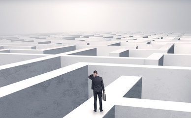 Small businessman in a middle of a huge maze
