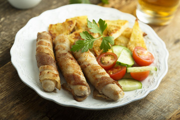 Grilled sausages wrapped with bacon