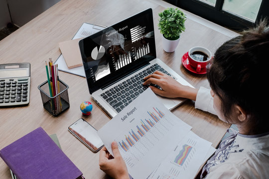 Business woman working at office with laptop and documents on his desk.Business analysis and strategy concept. - Powered by Adobe