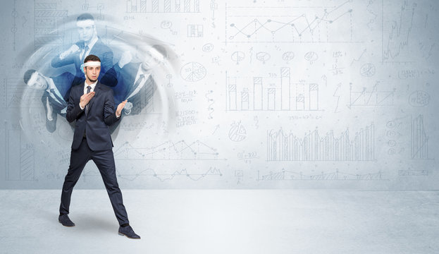 Young businessman in suit fighting with chart and report concept
