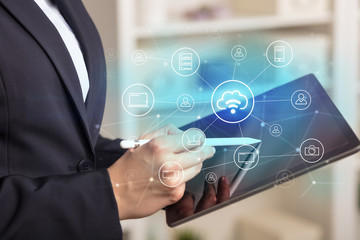 Business woman using tablet with network security and online storage system concept
