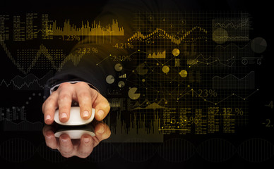 Hand using wireless mouse with financial concept on dark background
