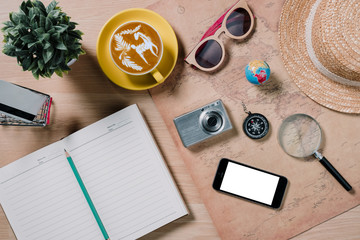 Flat lay traveler accessories on wooden background,Essential vacation items with copy space.