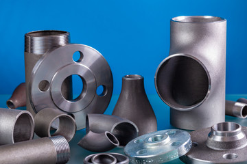 Set of steel welding fittings like tees, elbows, flanges, reducers, sockets, nipples, cups and...