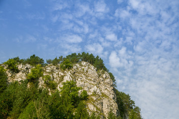 A beautiful landscape of cliffs in forest in Low Tatra region. Sunny day, colorful scenery in Slovakia, Europe.