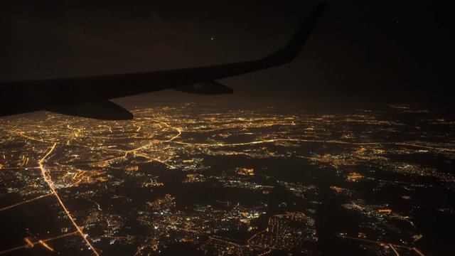 View from the window of the plane at night. Lights on approach to landing at airport