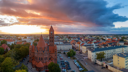 The Roman Catholic Co-Cathedral St. Stanisław Biskupa Martyr in Ostrow Wielkopolski, Poland. Aerial view to church and old town during sunset.