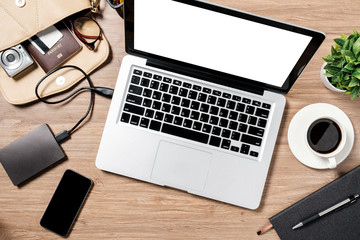 Top view of Mockup blank screen laptop on desk. Workspace with laptop and office supplies.