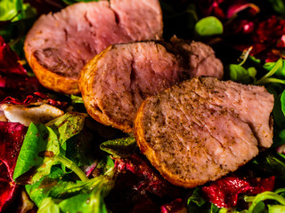 Pork loin chops with salad. Healthy colorful meal. Dark mood photography.