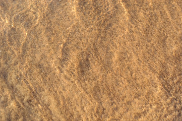 Abstract natural background of sand under water.