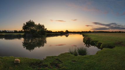 Fototapeta na wymiar Beautiful dawn landscape image of River Thames at Lechlade-on-Thames in English Cotswolds countryside