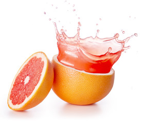 red juice splashing out of a grapefruit isolated on white background
