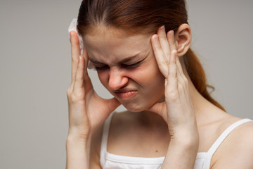 woman holding her head headache runny nose sore throat flu