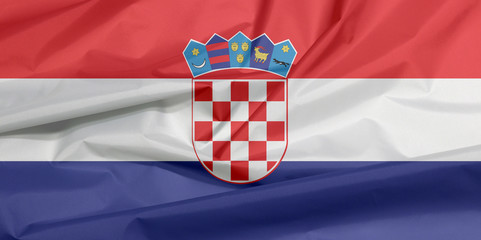 Fabric flag of Croatia. Crease of Croat flag background, red white and blue with the Coat of Arms...