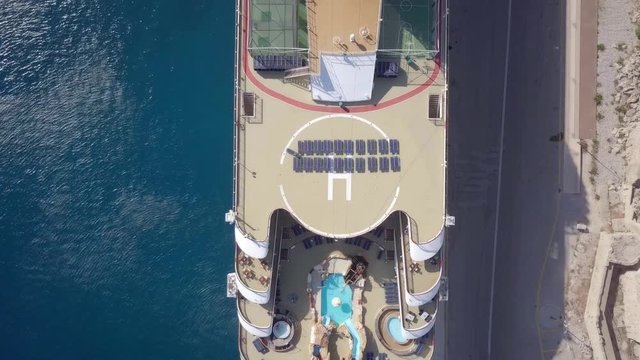 Large Cruise ship docked at port - Top down aerial footage