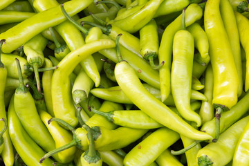 Green chilli peppers on market stall