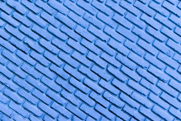 Oblique background of old vintage blue brick wall. The surface of brick texture for interior or copy space.