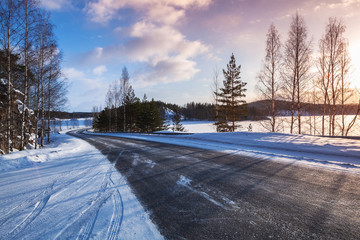 Empty rural road on a lake coast, winter