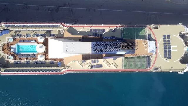 Large Cruise ship docked at port - Top down aerial footage