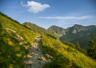 Fototapeta na wymiar A beautiful hiking trail in the mountains. Mountain landscape in Tatry, Slovakia. Walking path scenery.
