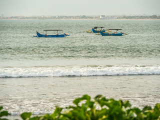 Jukungs anchored of shore Kuta Bali