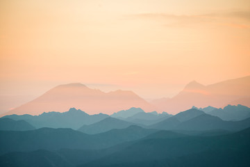 Colorful, abstract double exposure of mountains in sunrise. Minimalist scenery with color gradients. Tatra mountains in Slovakia, Europe.